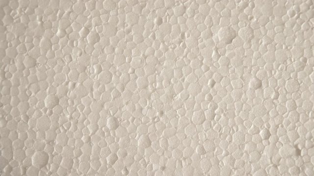 White polystyrene foam surface background texture. Dolly sliding shot 4K ProRes HQ codec