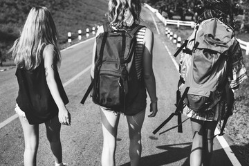 Diverse Backpacker Women Walking along The Street Side