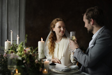 Bride and Groom Clinging Wineglasses Together at Wedding Reception