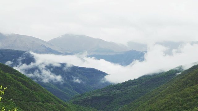 Clouds roiling and flowing over peaks of Mountain Range