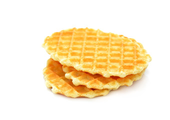 A stack of golden round waffles isolated on white background.Set of three tasty brown biscuits.