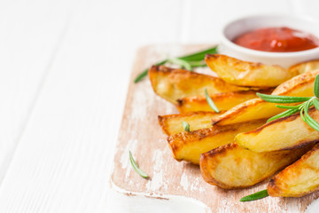 Baked potatoes with red sauce on white background, selective focus