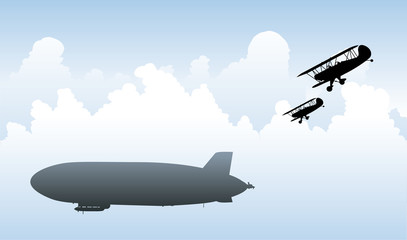 A silhouette of a pair of biplanes racing to intercept a zeppelin during World War One. © blambca