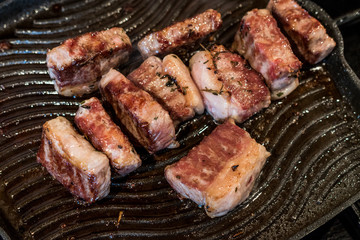 Lamb Meat is frying in a pan.