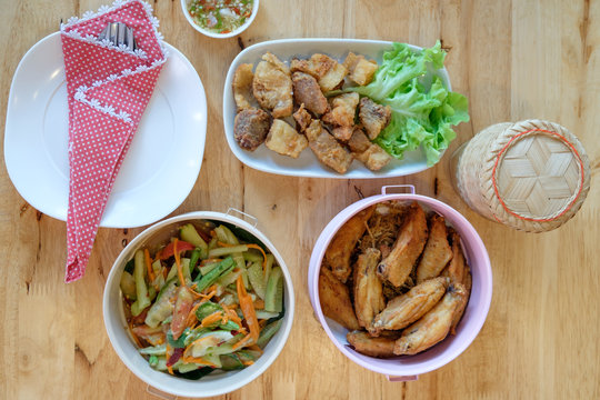 Top view of papaya salad ( Som tam) with consists of grilled chicken, fried pork