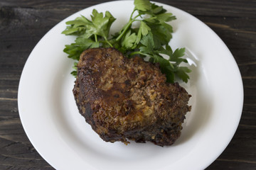 Fried liver on a white plate. Tasty and hearty dish.