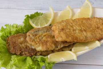 Fish in batter. Tasty and nutritious food. Fried fish on a wooden table.