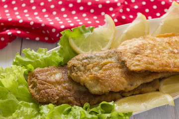 Fish in batter. Tasty and nutritious food. Fried fish on a wooden table.