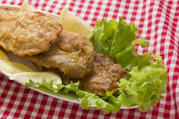 Fish in batter. Tasty and nutritious food. Fried fish on a wooden table.