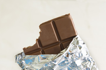 A tasted chocolate bar in silver foil
