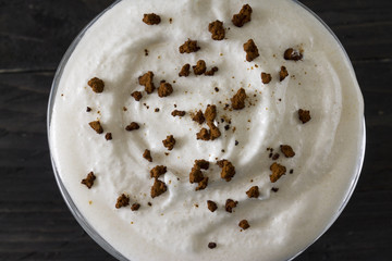 Eggnog on a wooden table. A festive egg drink. Christmas time.