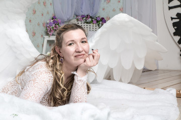 Ugly woman in a white dress with white wings