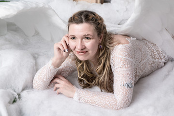 Ugly woman in a white dress with white wings