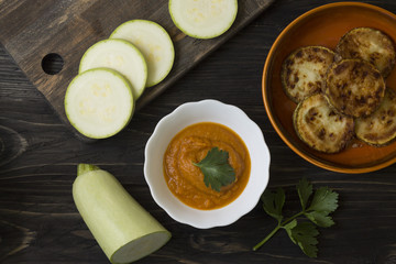 Squash caviar in a white bowl on a wooden table. Healthy food.