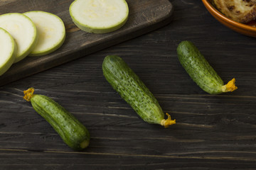 Cucumbers on a wooden table. Useful vegetables. Healthy eating.