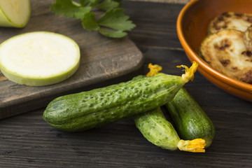 Cucumbers on a wooden table. Useful vegetables. Healthy eating.