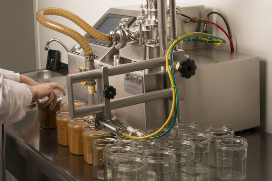 Automated food factory put caramel jam in jars