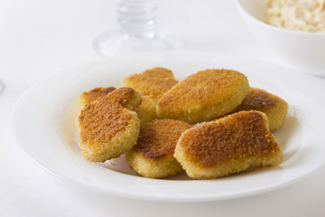 Chicken nuggets on a white plate. Delicious fast food.