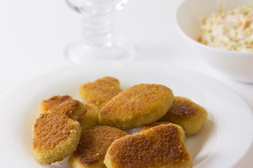 Chicken nuggets on a white plate. Delicious fast food.