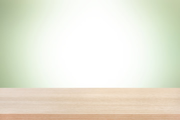 Wood table top on light green background