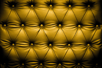 Luxury golden leather texture with buttoned pattern