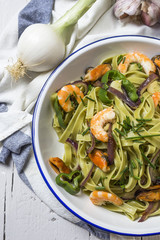 Green tagliatelle with seafood. Mussels; Prawns