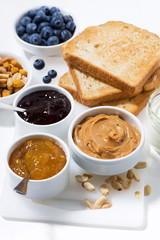 peanut butter, jams and toasts for breakfast, vertical closeup
