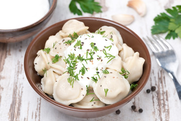 traditional dumplings with sour cream and dill, top view