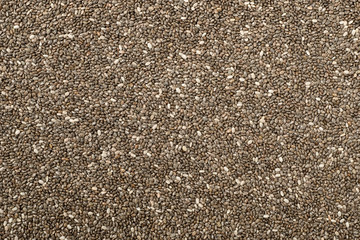 food background of chia seeds, top view