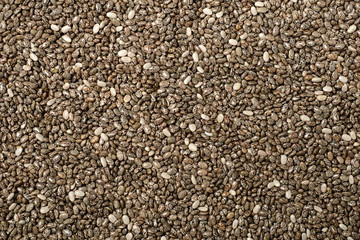 food background of chia seeds, top view