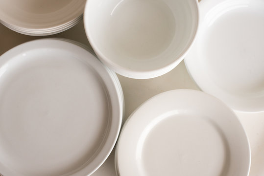 High angle full frame view of white dinner plates and bowls