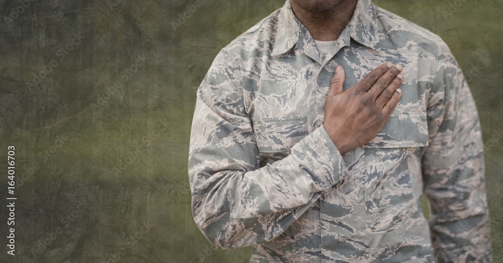 Poster Soldier man standing against green background