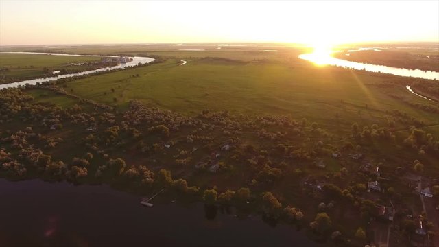 Fabulous view on the Dnipro river, its picturesque blue waters, a nice inflow at sunset in summer. The riverbanks are covered with greenary and look gorgeous and great. The skyscape is splendid