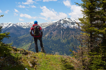 Fototapeta na wymiar Hiker admires a panorama of mountains