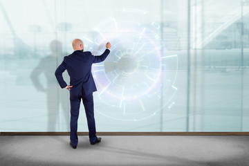 Businessman in front of a wall designing a futuristic interface - Innovation concept