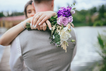 Elegant gentle stylish groom and bride near river or lake. Wedding couple in love