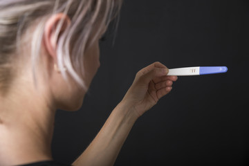 Woman holding pregnancy test, New life and new family concept.