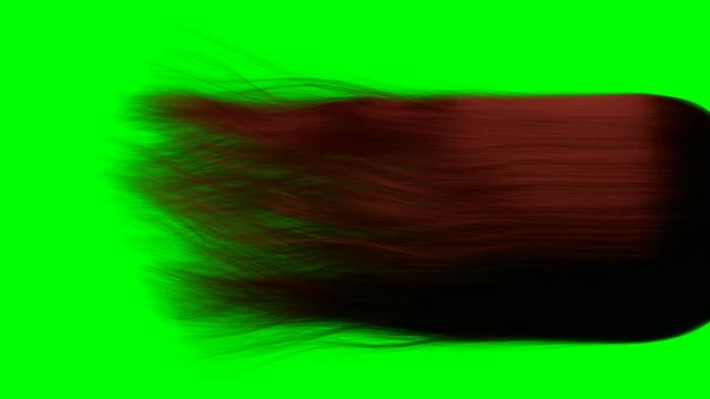 A close up of a long length of red hair blowing and swaying in slow motion before settling on a green screen background