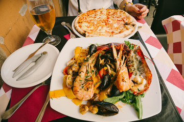 Seafood pasta, pizza and beer in Italy