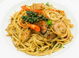 Spaghetti spicy with seafood on a white plate