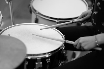 The drummer's hands with chopsticks behind the drum set. Baltic Drum Summit 2017. Riga, Latvia.