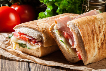 Toasted panini with ham, cheese and arugula sandwich - 164022920