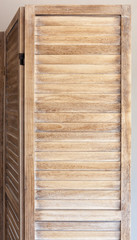 Close up of wooden folding screen.