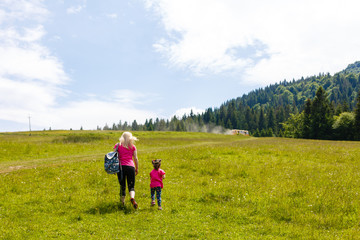 Fototapeta premium mother and little daugther hiking in mountains
