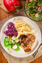 Pork roulade with french fries with salad