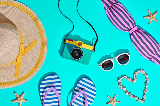 Beach Sunny Set. Fashion Summer Accessories, Film Camera, Stylish Swimsuit Bikini, Trendy Sunglasses, fashion Hat. Hot Vibes. Sweet Bright summer color. Creative Fun Art. Retro Design camera on Blue