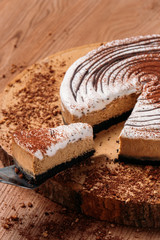 Slice of cheesecake with Chocolate powder on wooden background