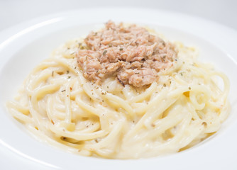 Pasta Carbonara with tuna on a white plate