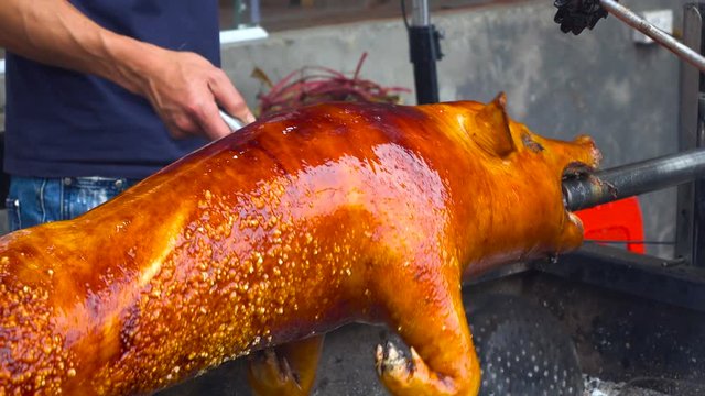 Roasting piglet , grilled pig at street food market in Sa Pa, Vietnam. Close up stock footage.