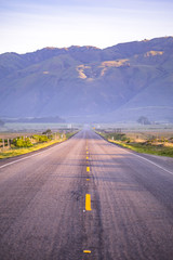 Sunrise gives tones to this rural road